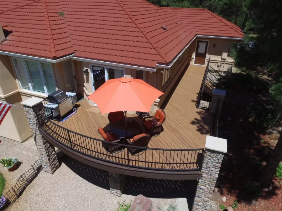 Custom Decks curved deck trex havana gold decking vintage lantern accent custom wrought iron railing perry park colorado