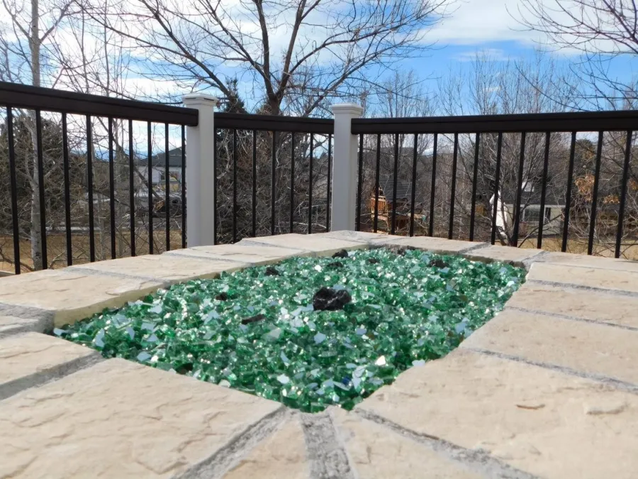 Custom Decks colored glass filling burner area custom fire pit Aurora Colorado