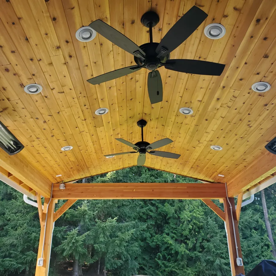 Custom Decks custom gable roof patio cover 6x6 support posts stained glulam beams rustic cross braces 12 can lights 3 heaters Redmond Washington