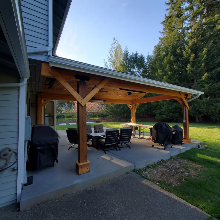 Custom Decks custom gable roof patio cover 6x6 support posts stained glulam beams rustic cross braces 12 can lights Redmond Washington