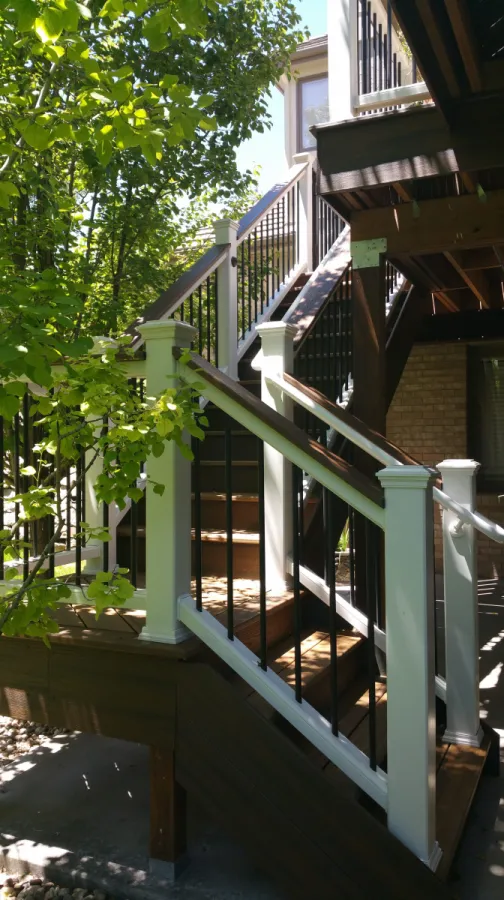 Custom Decks Standard 4 wide L shaped trex staircase tiki torch tread white rise trex transcend rail Littleton Colorado Custom Decks Standard 4 wide L shaped trex staircase tiki torch tread white rise trex transcend rail Littleton Colorado